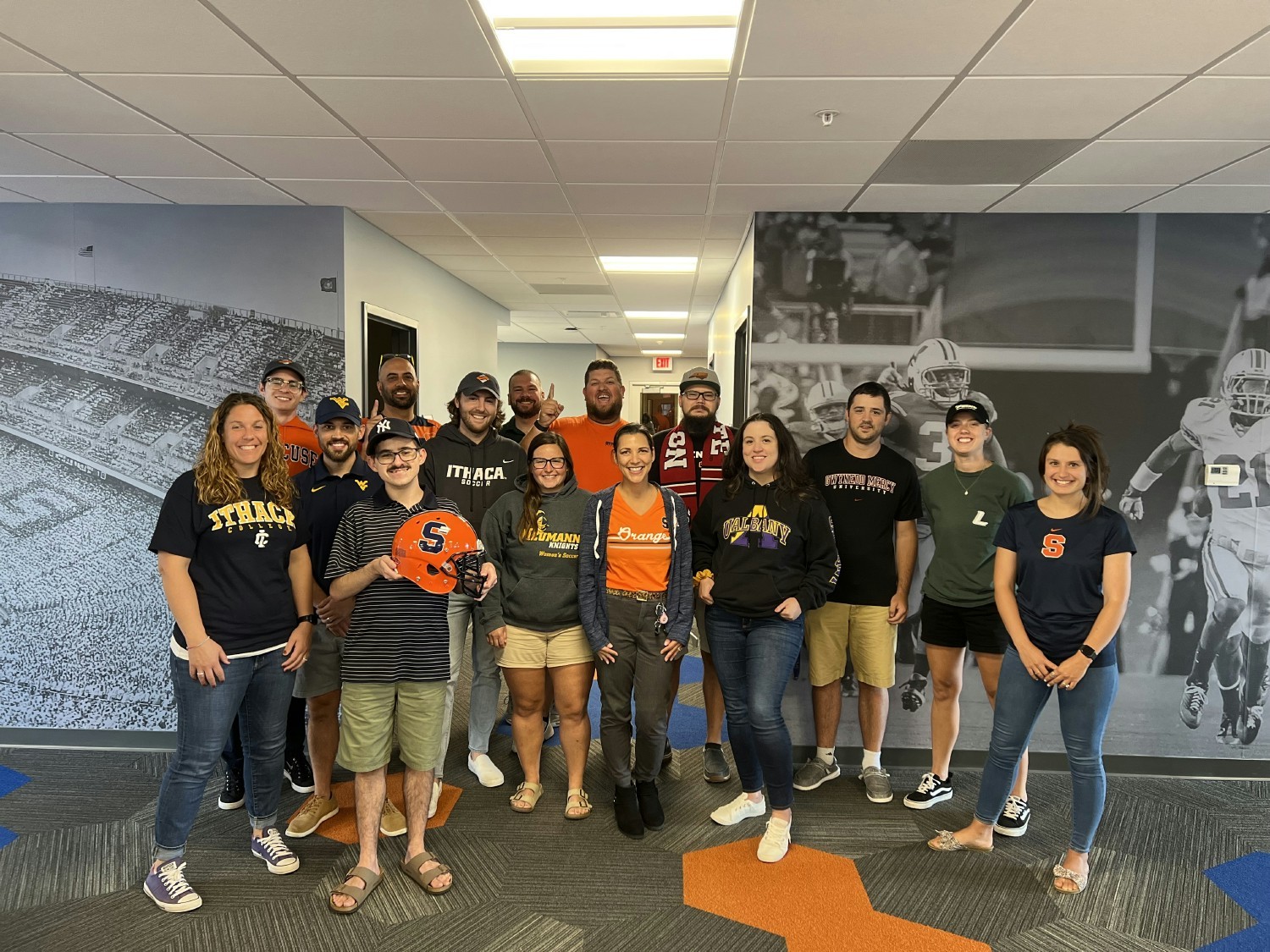 Members of the SIDEARM team gather in the Syracuse office for College Colors Day.