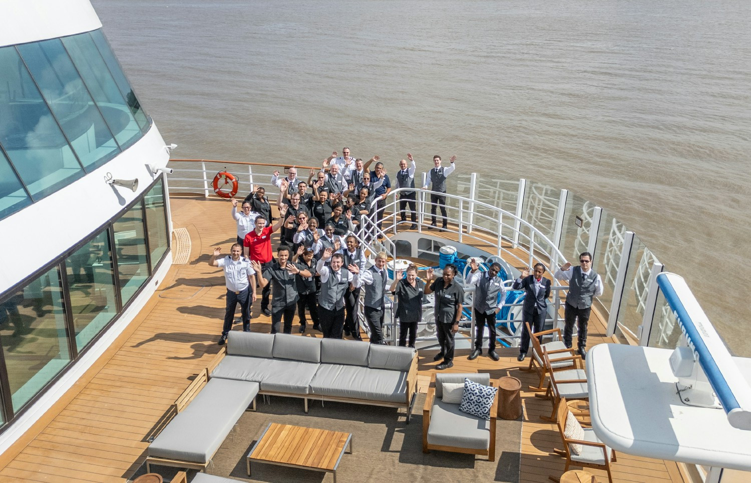 The attentive crew of the Viking Mississippi assembles for a group photo on board.