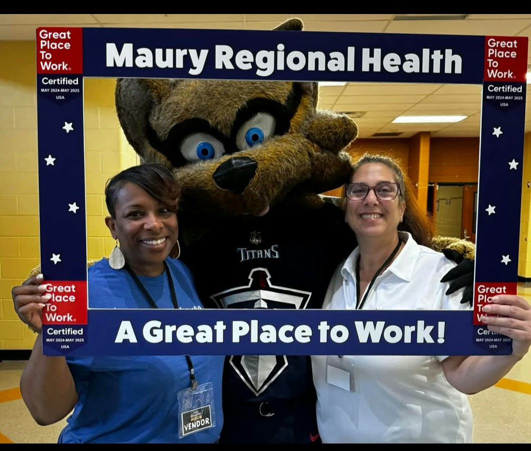 Employees proudly showcase our Great Place to Work designation while connecting with job seekers at a local job fair.