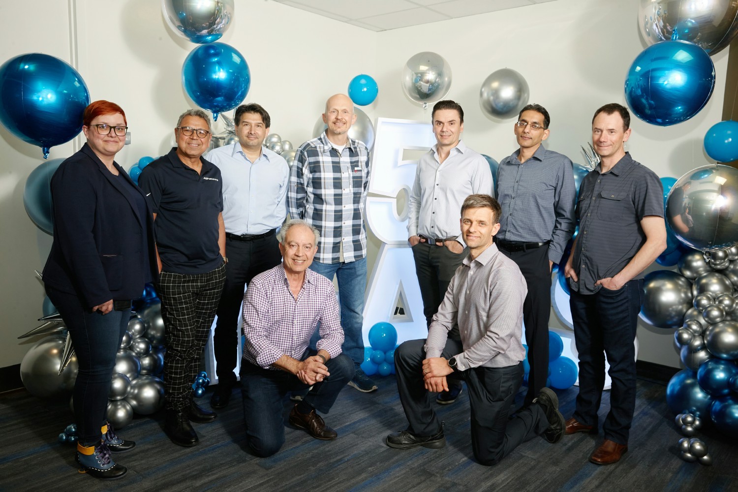 Executive team photo at 5-year anniversary event. 