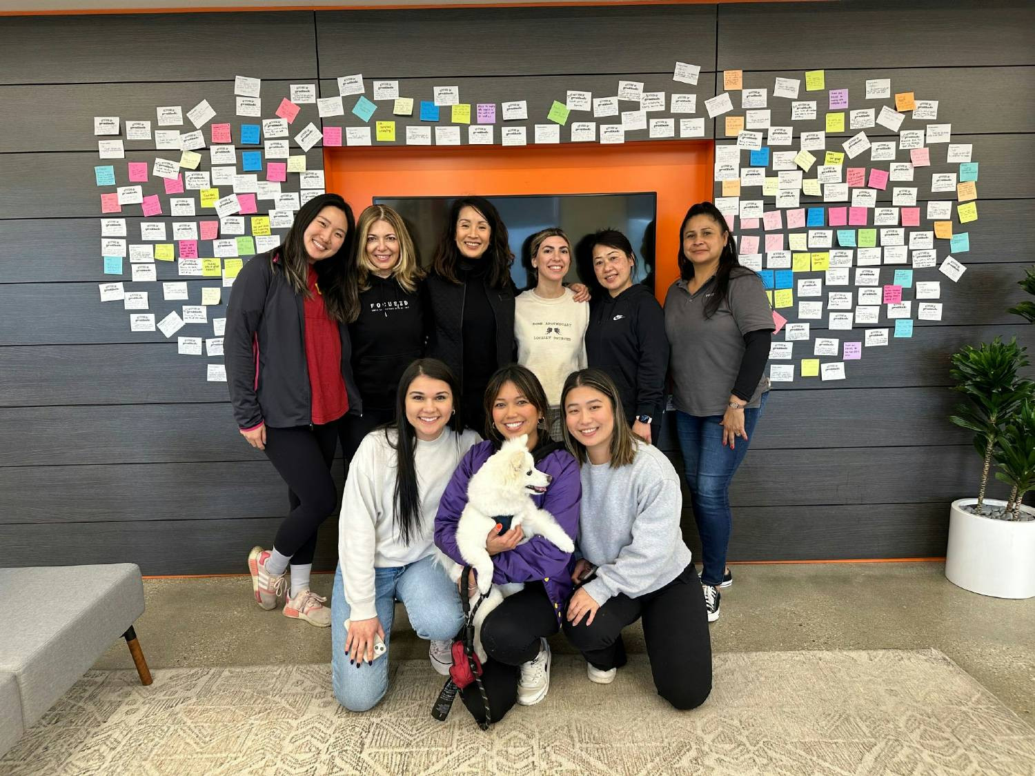 Members of Women@Zest, just one of our homegrown ERGs, gathered in front of our favorite gratitude wall.