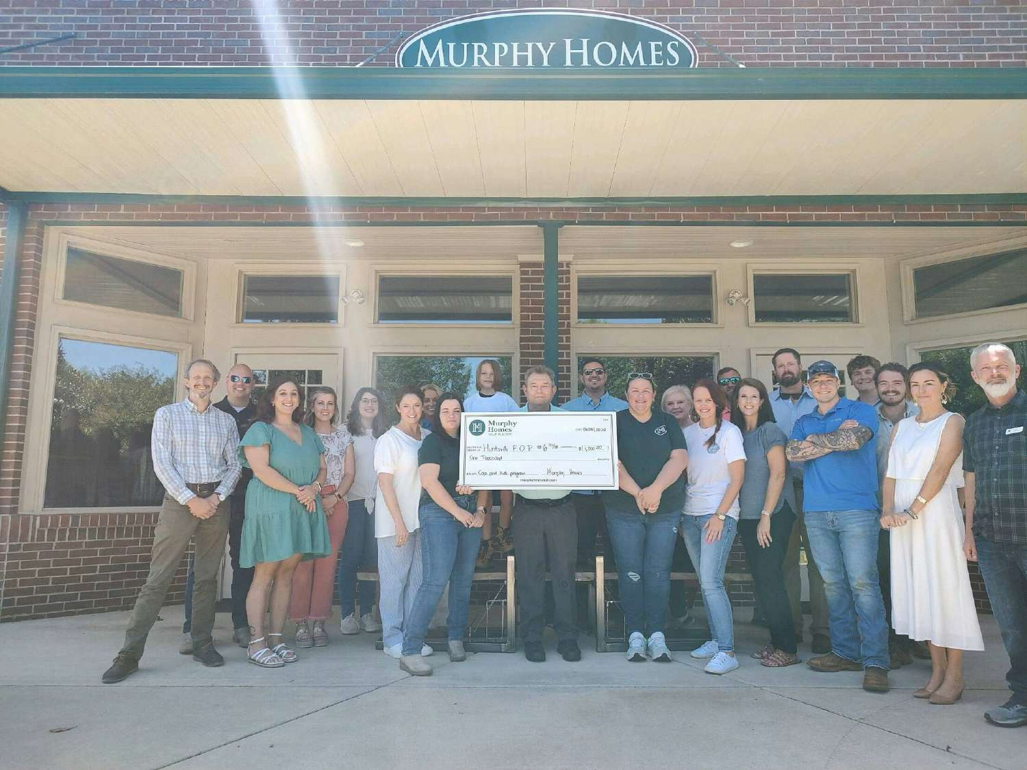 Presenting a donation check to a local charity at our monthly town hall meeting. 