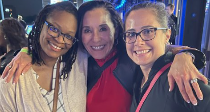 Our President, Mimi Dew, posing with employees at TopGolf.