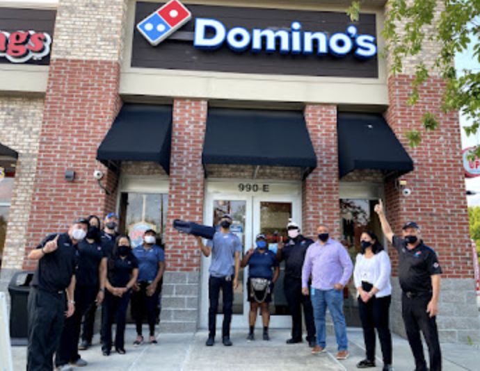 Domino's team in front of one of our locations during Covid