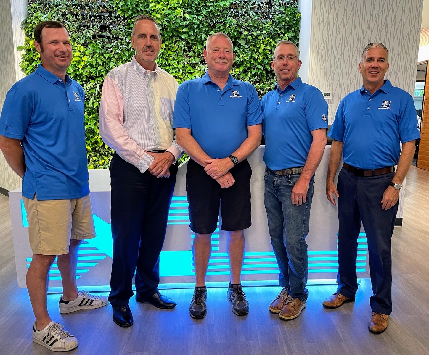 Our hardworking factory leadership team gathered for a photo in front of our gorgeous living plant wall.