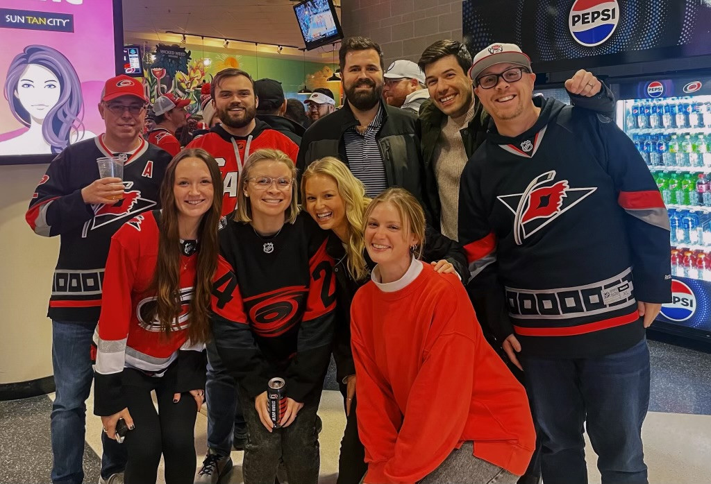 Team members enjoying an outing at the Carolina Hurricanes game.