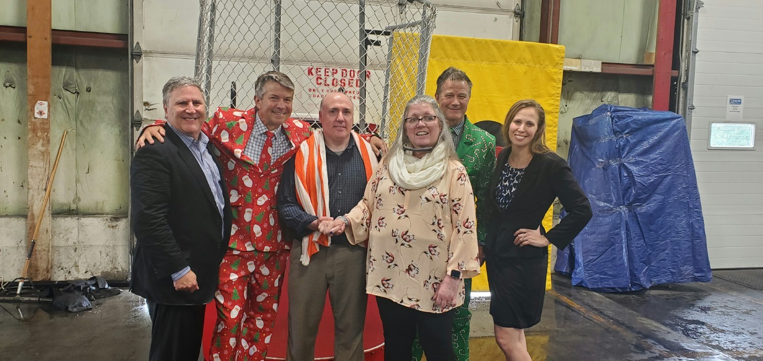 The executive team (a little wet) and our employee who was diagnosed with ALS, post our dunk tank submersion fundraiser.
