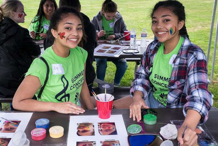 Volunteers manning a painting station at one of our many events 