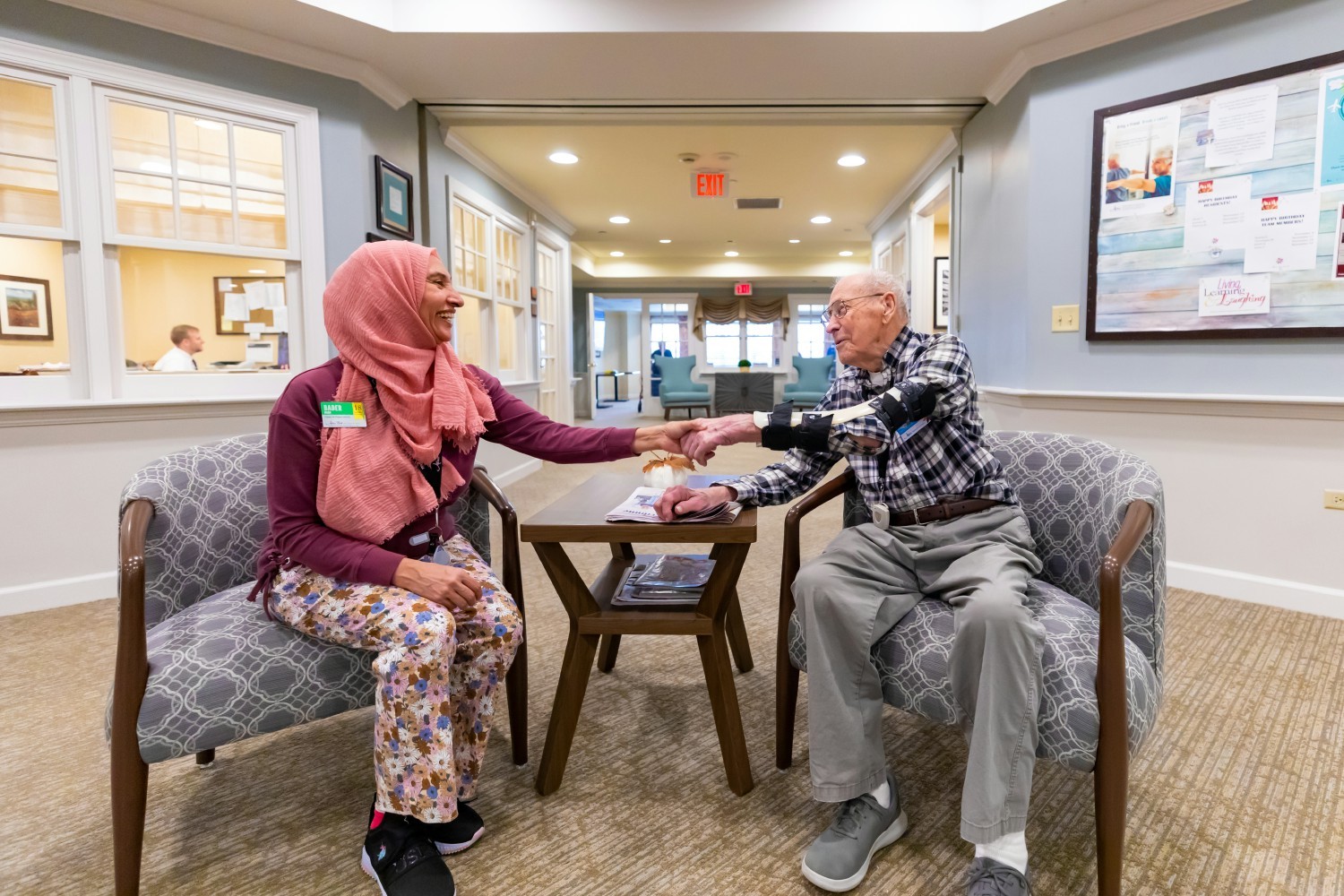Badar, an Engage Life Program Instructor at Atria Park of Glen Ellyn, spends time with one of the residents. 