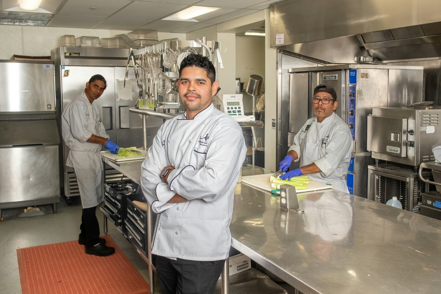 Adrian, a member of the Culinary Team at Atria Rye Brook, poses in the community kitchen.