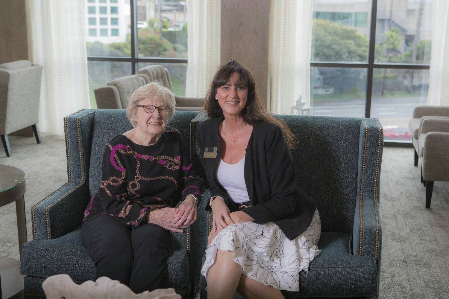 Lyn, an Engage Life Director at Atria Newport Beach, smiles with a resident.