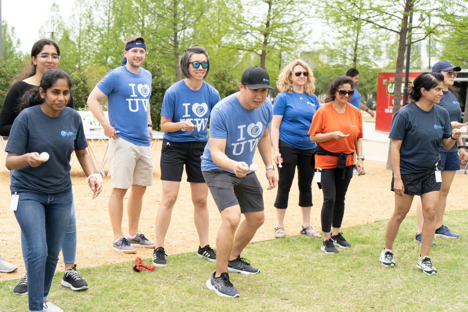 Egg relay race at UWorld's annual Field Day, where employees participate in outdoor games and eat lunch together.