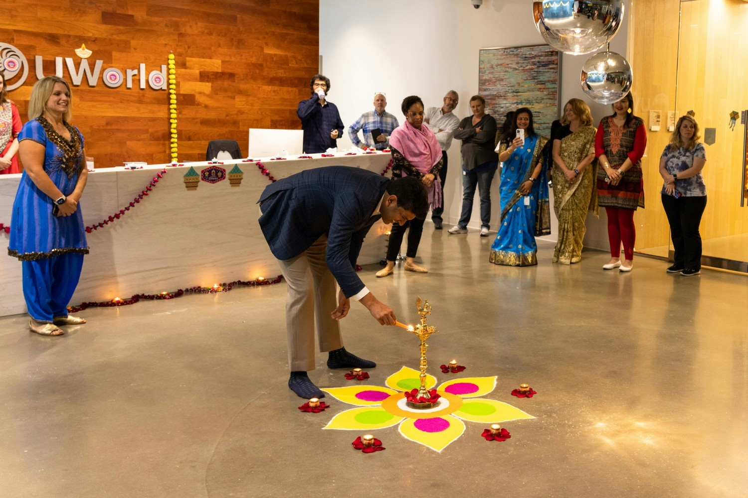 Chandra S. Pemmasani, MD, Founder & CEO of UWorld, lighting a Diya lamp to celebrate the start of Diwali.