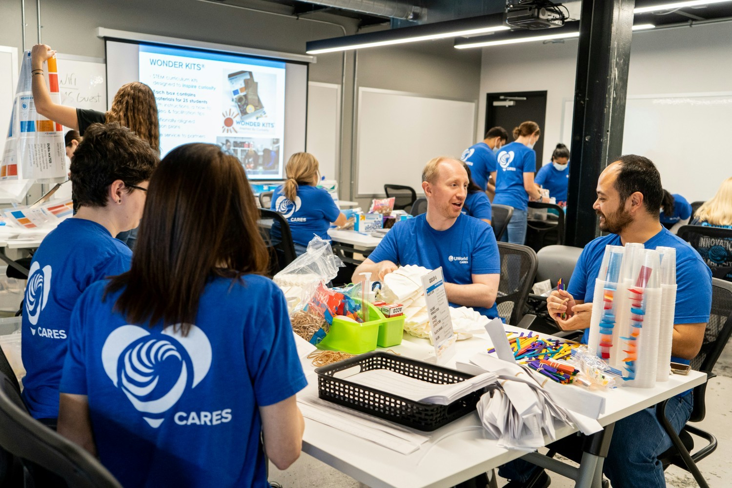 An employee volunteer event putting together STEM-related kits for a local-area school.