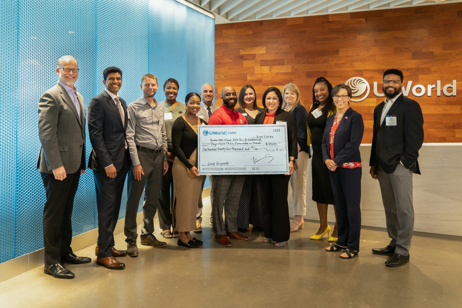 Check presentation to UWorld Cares recipients. UWorld Cares is the philanthropic arm of the company.