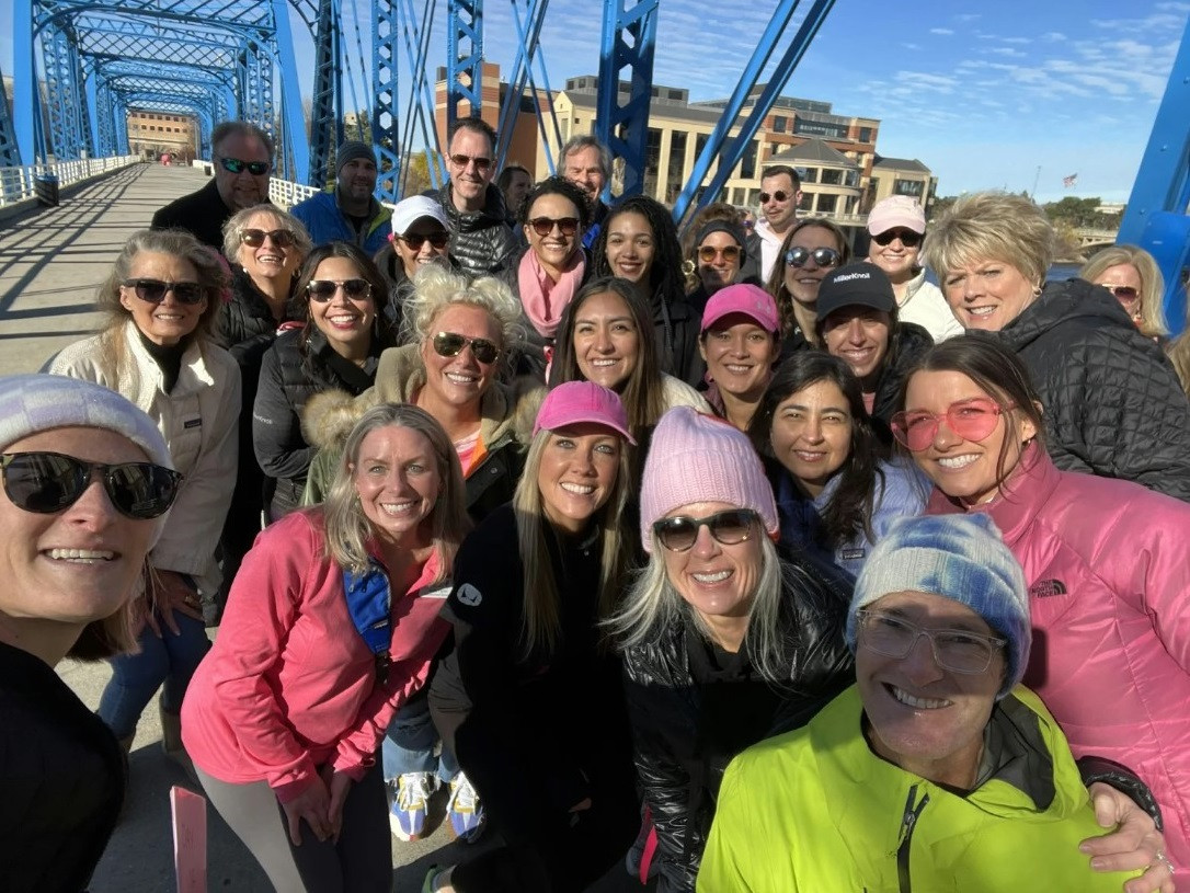 MillerKnoll CEO Andi Owen and employees pose for photo during a breast cancer awareness walk in Southwest Michigan.