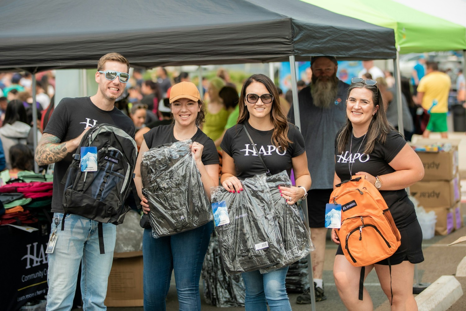 Employees volunteer at HAPO’s “Back to School Bash”, an event to provide school supplies and resources to kids in need.