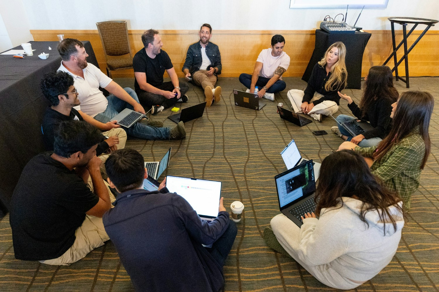 Unstructured team members participate in fun cross-functional team challenges at a company-wide offsite.