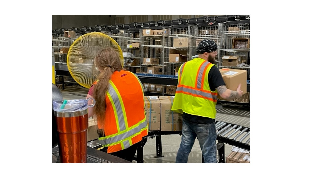 Shipping employees working together on the line