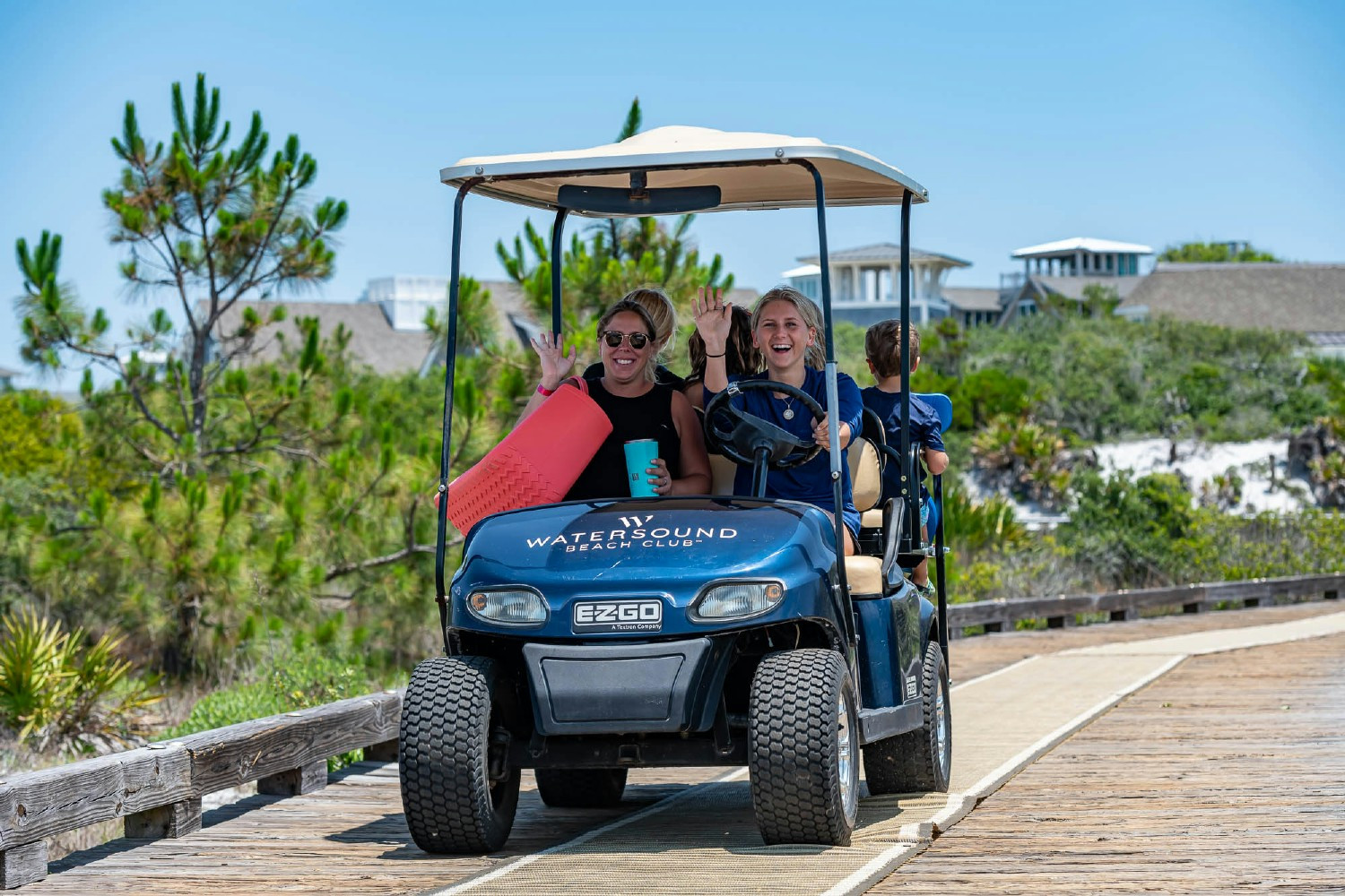 Watersound Club Members enjoying a team member chauffeured golf cart ride from the pool directly to the beach! 