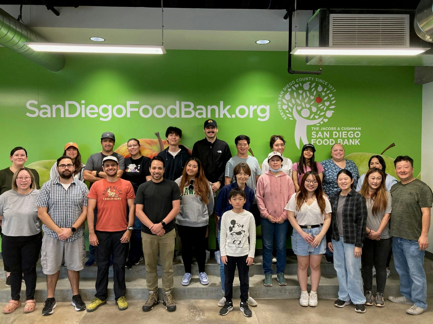TEAM MEMBERS AND GUESTS VOLUNTEER AT THE SAN DIEGO FOOD BANK AND ASSIST WITH FOOD SORTING AND MEAL PACKAGE ASSEMBLY.