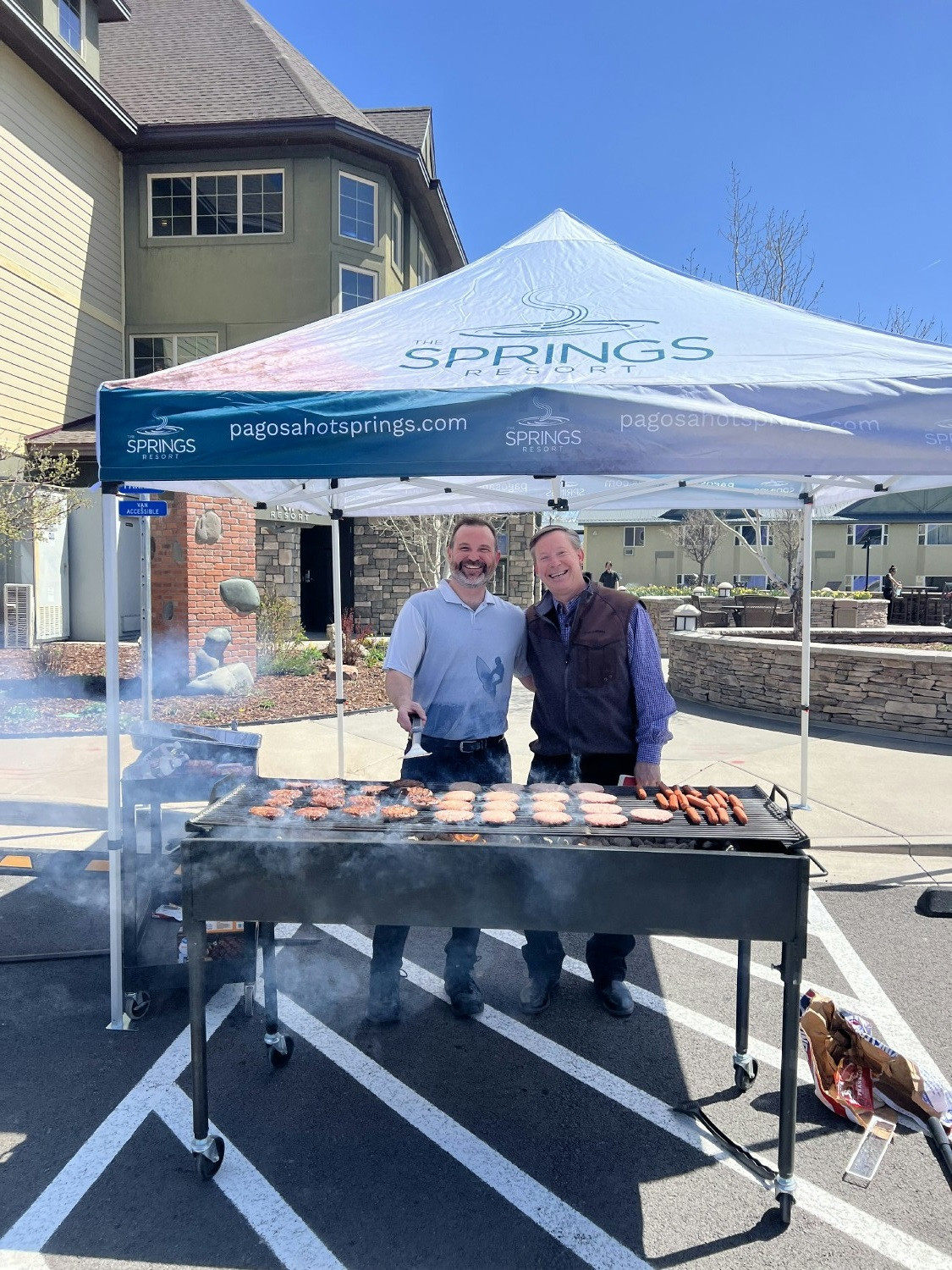 GM and Director of People and Culture Grilling 100's of burgers during the monthly Associate Luncheon