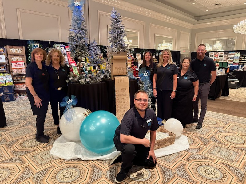 Display of group working at a customer show promoting holiday items we represent.