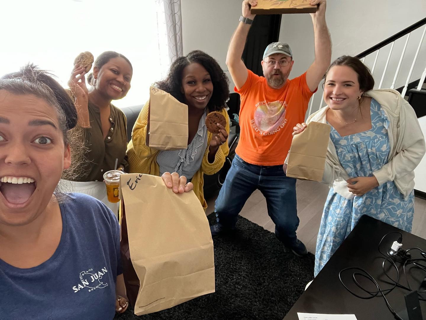 The team enjoys a free lunch from a client for meeting tight deadlines. 