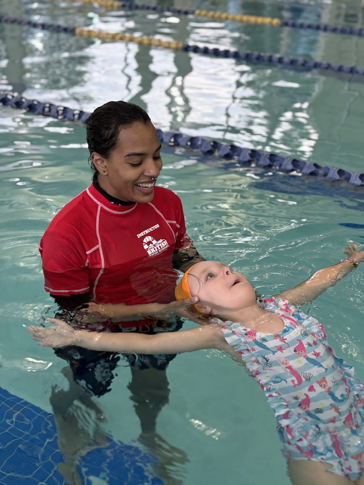 Mr. Jael helping a student learn to back float 