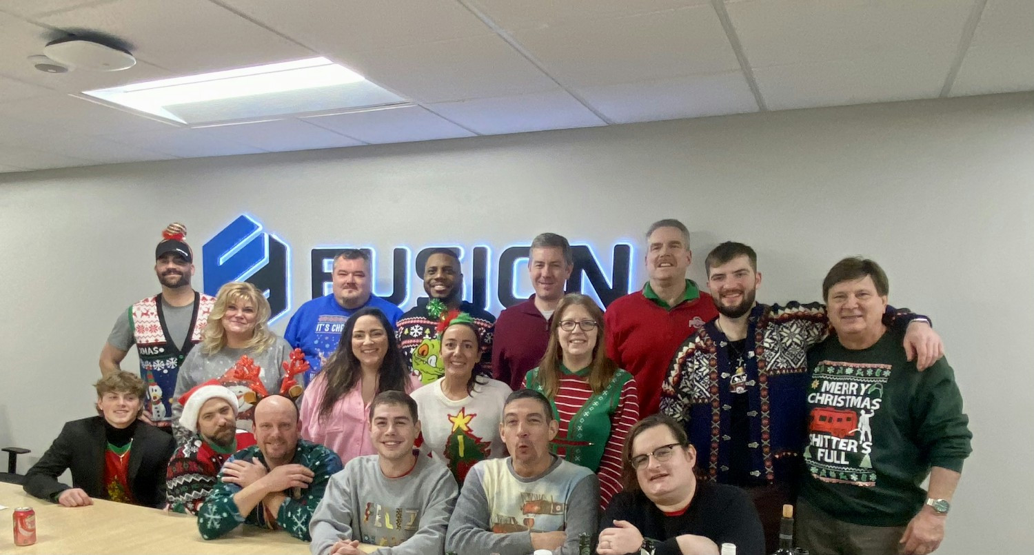 Our team rocking their best (and ugliest) sweaters at the annual Fusion Digital Ugly Sweater Party—holiday fun for all!