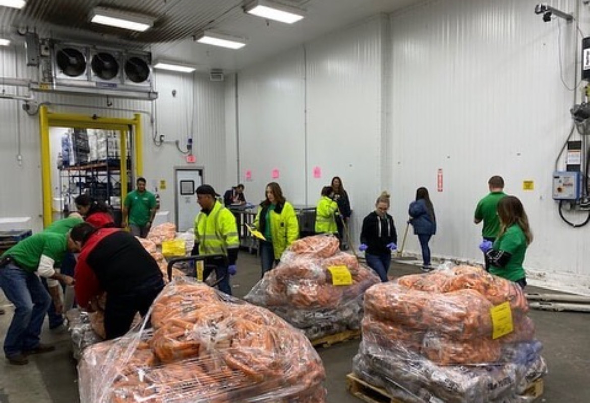 Envent team members hard at work packaging food at the Houston Food Bank.