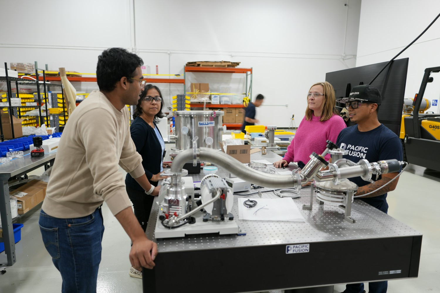 Team members meeting to discuss their progress and work together to problem solve.