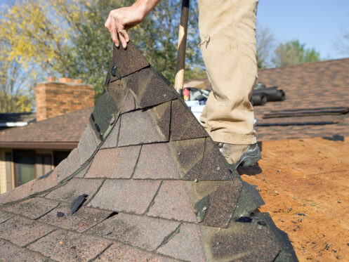 Our crew tearing off old roofing